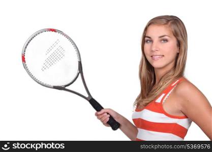 Female teenager holding tennis racket