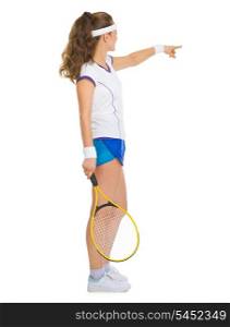 Female tennis player pointing on copy space
