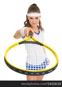 Female tennis player pointing racket in camera