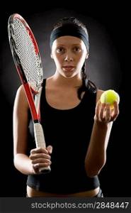 Female tennis player with racket and balll on black background