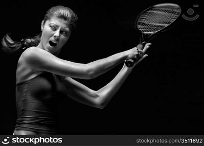 Female tennis player with racket ready to hit a tennis ball.
