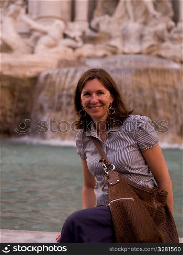 Female tourist at Trevi Fountain in Rome Italy