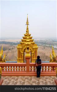 Female tourist at Wat Phra That Doi Phra Chan on the top of mountain in Mae Tha District, Lampang, Thailand