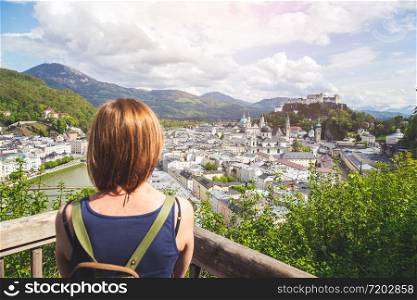 Female tourist is enjoying the view over the historic district of Salzburg