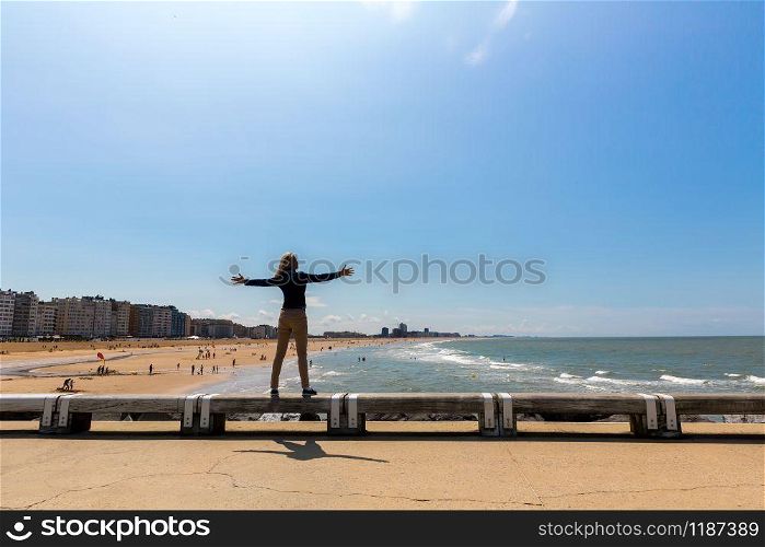 Female tourist on city beach, sea coast, Europe. Summer tourism and travels, famous and popular places for vacation tour or holidays