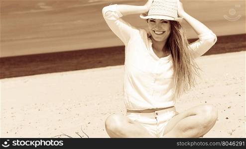 Female tourist resting on beach.. Tourism and traveling. Happy attractive woman tourist resting on sunny beach. Young girl enjoy her free time on seaside. Summer time.