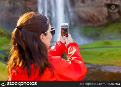 Female tourist taking pcitures with her phone
