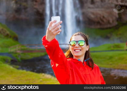 Female tourist taking pcitures with her phone