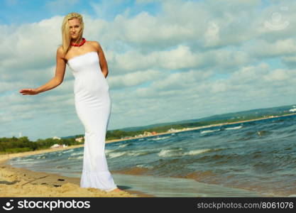 Female tourist walking on beach.. Tourism and recreation. Beauty attractive woman walking on sea edge. Female tourist resting on fresh air on seaside.