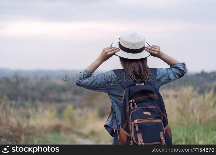 female tourist with backpack in the countryside