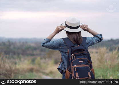 female tourist with backpack in the countryside