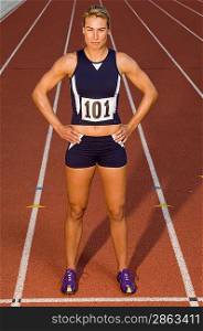 Female track athlete standing on track