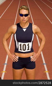 Female track athlete standing on track