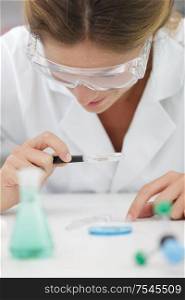 female trainee working with chemical liquids in lab