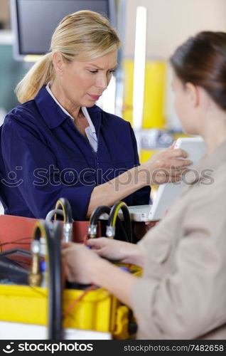 female trainer inspecting information from the tablet