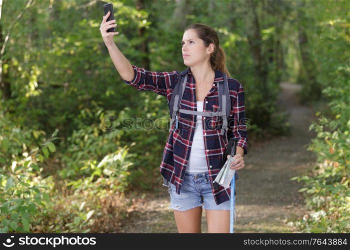 female traveler holding a compass on park