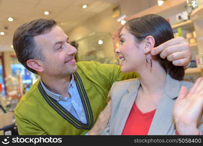 female trying earrings in retail store