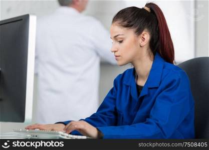 female tutor using computer in it class