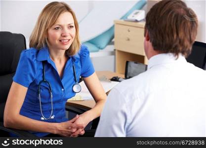 Female UK doctor talking to male patient
