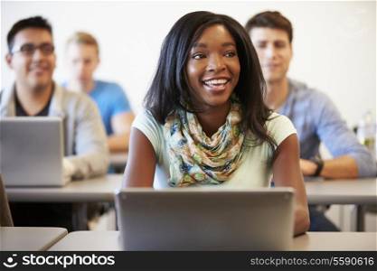 Female University Student Using Laptop In Classroom