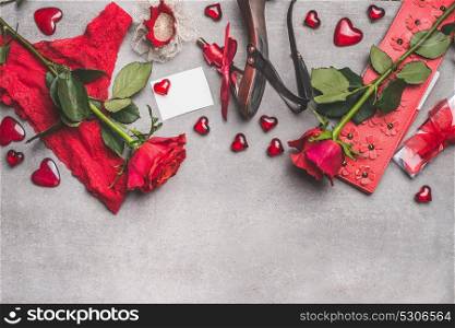 Female Valentines day or Dating accessories in red color: shoes, panties, roses flowers, candles, crown and blank paper card with heart on gray background, top view, border