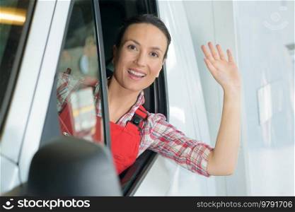 female van driver waving at camera