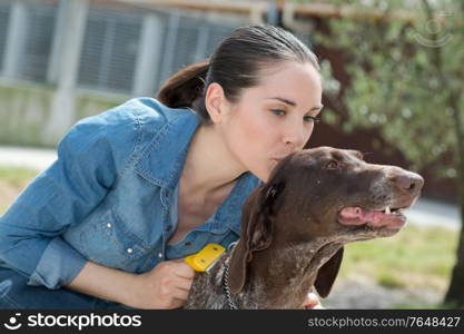 female vet stroking dog at animal shelter