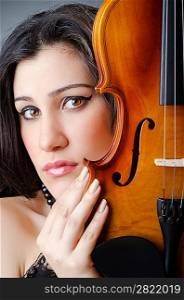 Female violin player against background