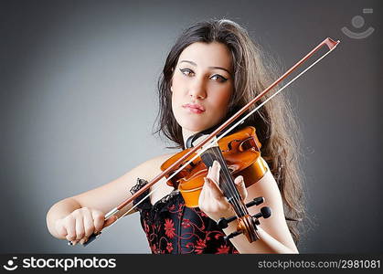 Female violin player against background