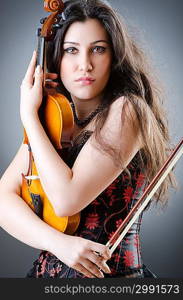 Female violin player against background