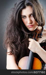 Female violin player against background