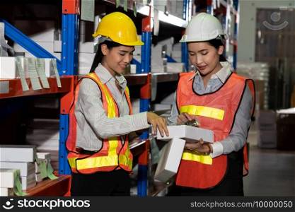 Female warehouse worker working at the storehouse . Logistics , supply chain and warehouse business concept .. Female warehouse worker working at the storehouse