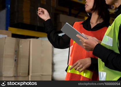 Female warehouse worker working at the storehouse . Logistics , supply chain and warehouse business concept .. Female warehouse worker working at the storehouse