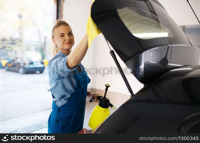 Female washer wipes wax spray, car wash service. Woman washes vehicle, carwash station, car-wash business