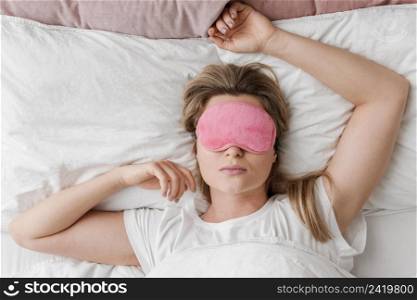 female wearing sleep mask her eyes