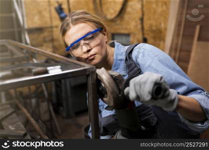female welder working studio