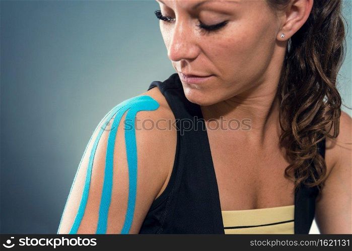 Female with kinesiotape on shoulder