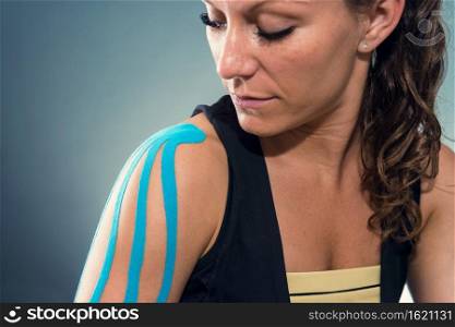 Female with kinesiotape on shoulder
