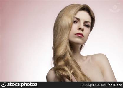 female with long shiny blonde hair style and fresh perfect skin. Hair-care and extension shoot
