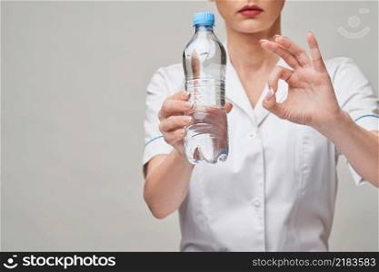 female woman nutritionist or dietician doctor healthy lifestyle concept - holding bottle of water.. female woman nutritionist or dietician doctor healthy lifestyle concept - holding bottle of water