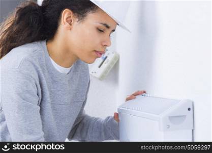Female worker fitting appliance to wall