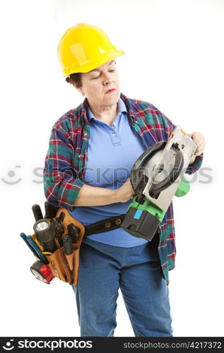 Female worker gets ready to fix a circular saw.