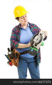 Female worker gets ready to fix a circular saw.