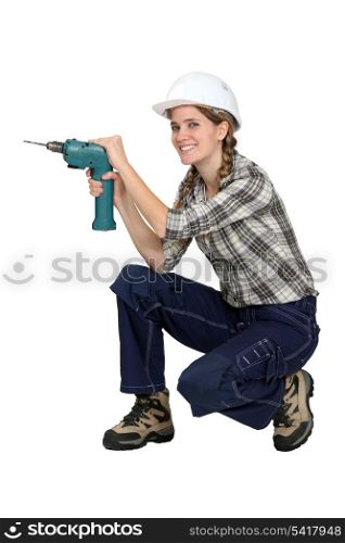 Female worker holding a drill.