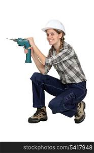 Female worker holding a drill.
