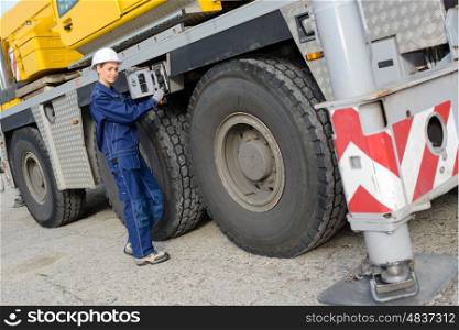 female worker inspecting her truck before driving