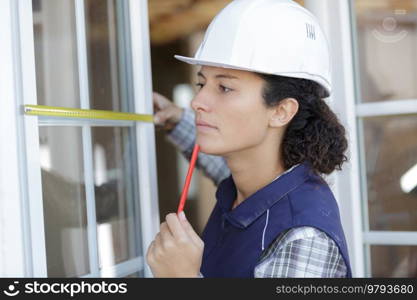 female worker measure the window