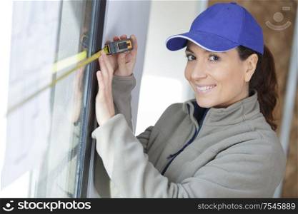 female worker measures a window
