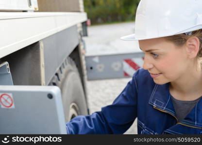 Female worker operating heavy goods vehicle
