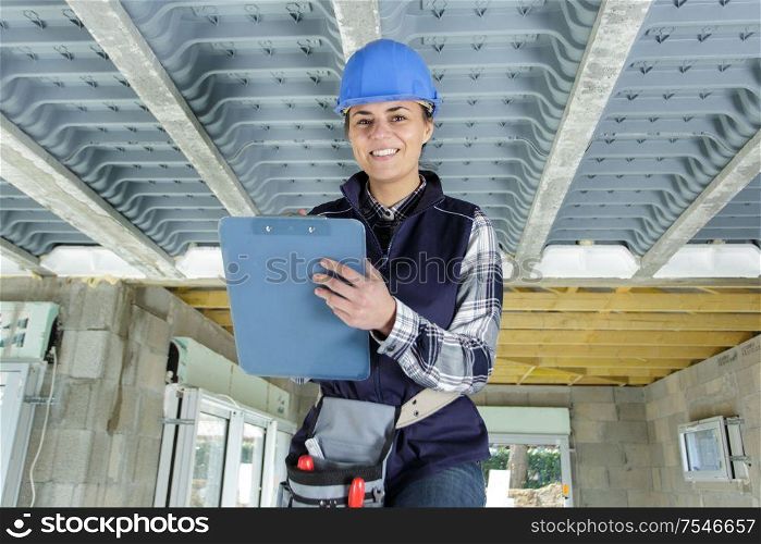 female worker taking inventory with clipboard